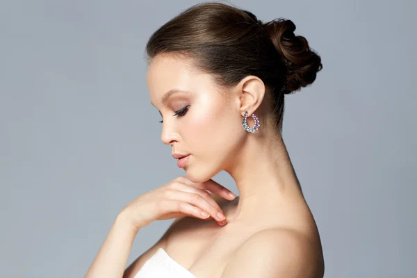 Close up of beautiful woman face with earring — Stock Photo, Image