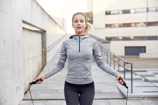 Woman exercising with jump-rope outdoors — Stock Photo, Image