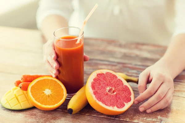 Menutup tangan wanita dengan jus dan buah-buahan — Stok Foto