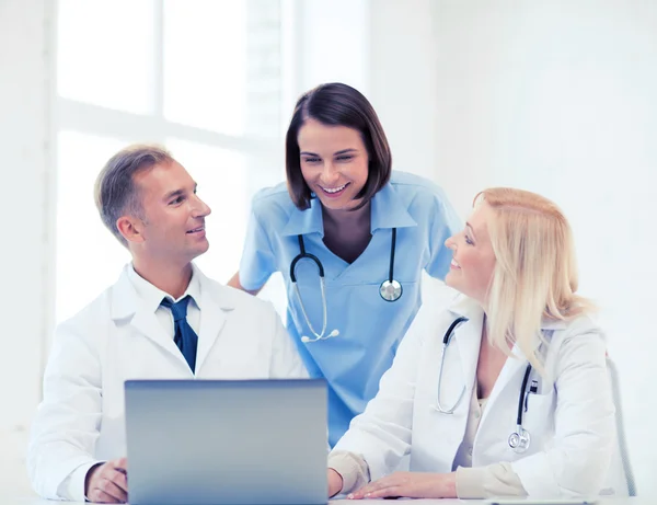 Group of doctors looking at tablet pc — Stock Photo, Image