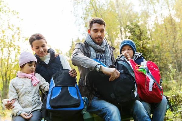 Happy family with backpacks at camp — Stock Photo, Image
