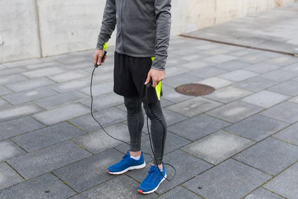 Close up of man exercising with jump-rope outdoors — Stock Photo, Image