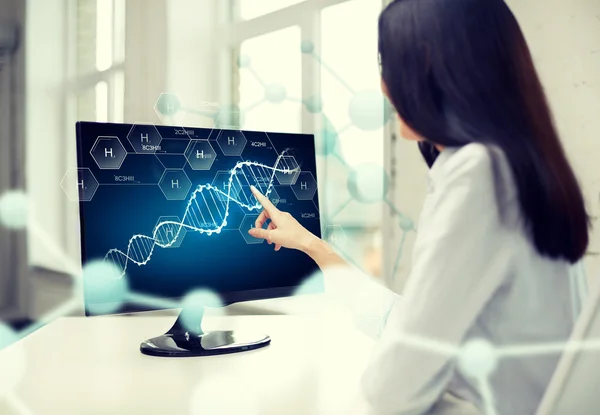 Close up of woman with dna molecule on computer — Stock Photo, Image