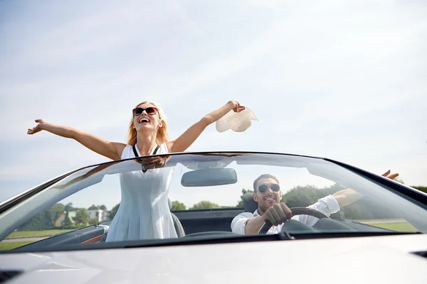 Happy man and woman driving in cabriolet car — Stock Photo, Image