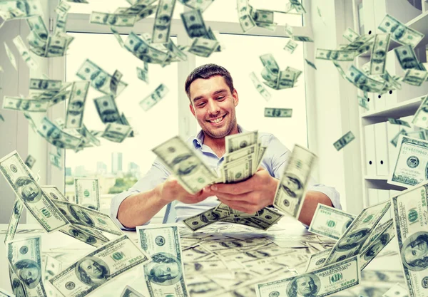 Happy businessman with heap of money — Stock Photo, Image