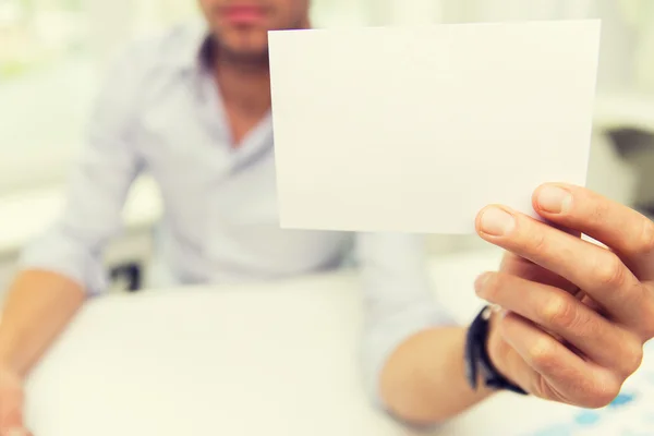 Close up of businessman with blank paper at office — Stock Photo, Image