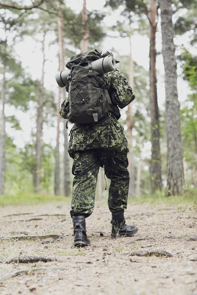 Ung soldat med ryggsäck i skogen — Stockfoto