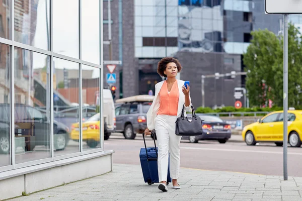 Donna africana con borsa da viaggio e smartphone — Foto Stock