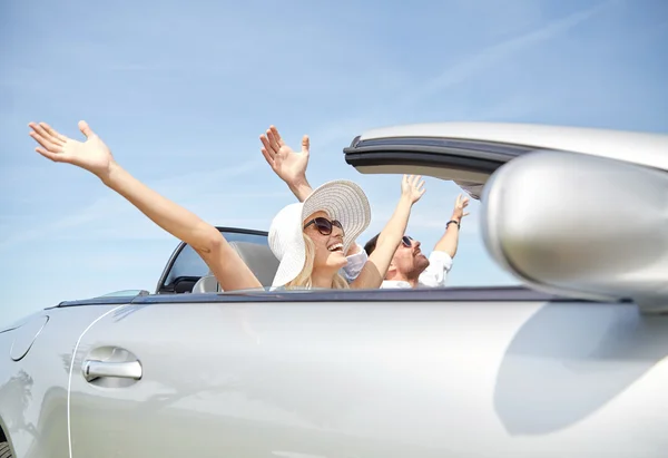 Happy man and woman driving in cabriolet car — Stock Photo, Image