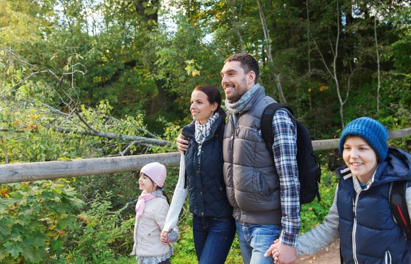 Famille heureuse avec sacs à dos randonnée dans les bois — Photo