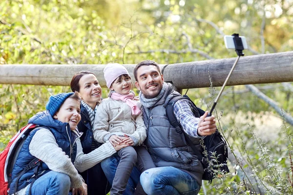 Famiglia felice con smartphone selfie bastone nel bosco — Foto Stock