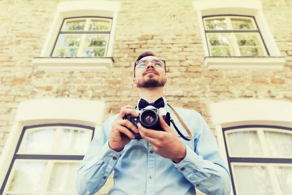 Happy young hipster man with film camera in city — Stock Photo, Image