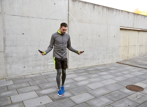 Man exercising with jump-rope outdoors — Stock Photo, Image