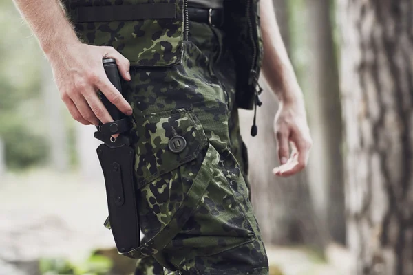 Close up of soldier or hunter with knife in forest — Stock Photo, Image