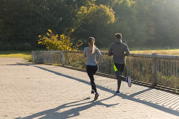 Couple running or jogging outdoors — Stock Photo, Image