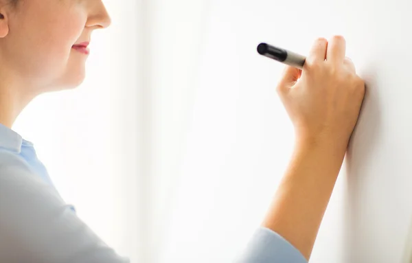 Close up of woman writing something on white board — Stock Photo, Image