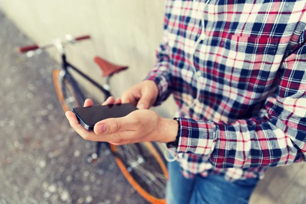 Close up of hipster man with smartphone and bike — Stock Photo, Image