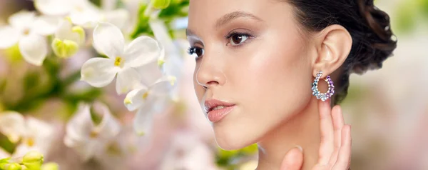 Close up of beautiful woman face with earring — Stock Photo, Image