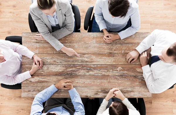 Close up of business team sitting at table — Stock Photo, Image