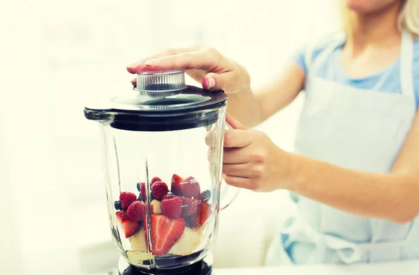 Close up of woman with blender making fruit shake — Stock Photo, Image