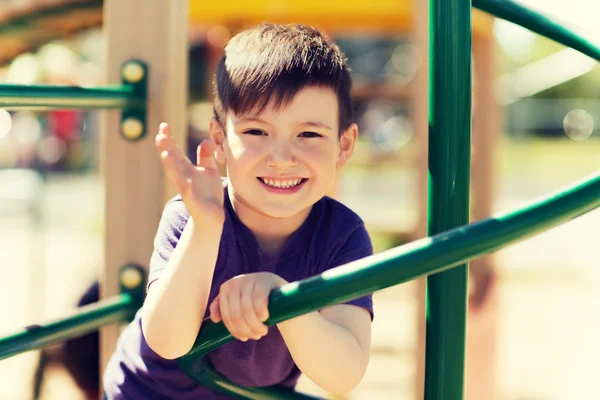 Happy little boy climbing on children playground — Stock Photo, Image