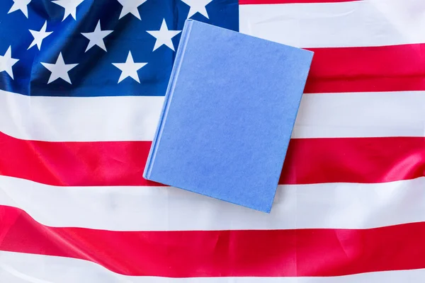 Close up of american flag and book — Stock Photo, Image