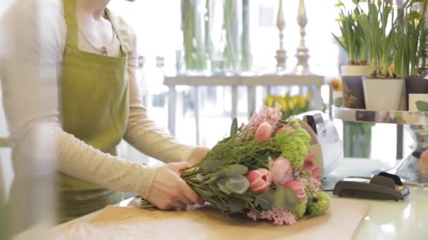 Floristería mujer con flores y hombre en floristería — Vídeos de Stock