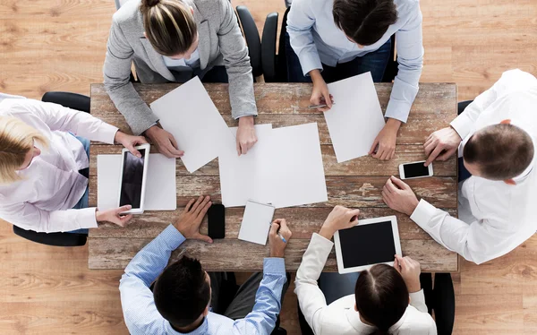 Close up of business team with papers and gadgets — Stock Photo, Image