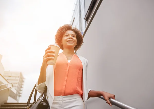 Happy african businesswoman with coffee in city — Stock Photo, Image