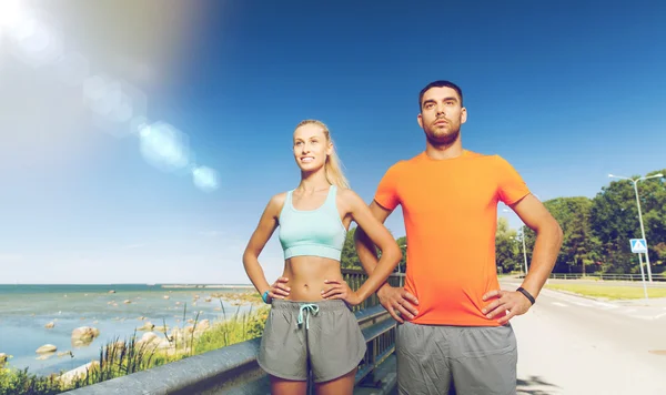 Happy couple exercising at summer seaside — Stok fotoğraf