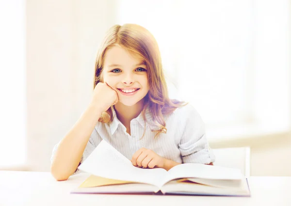 Little student girl studying at school — Stock Photo, Image