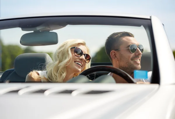 Happy man and woman driving in cabriolet car — Stock Photo, Image