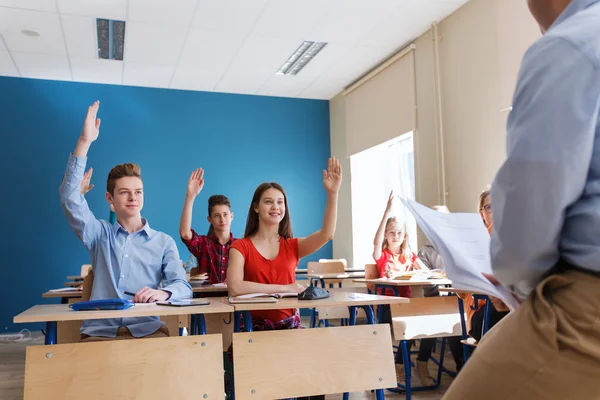 Group of students and teacher with papers or tests — Stock Photo, Image