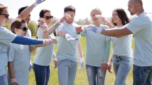 Groupe de bénévoles mettre la main sur le dessus dans le parc — Video