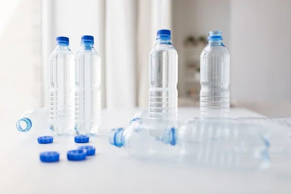 Close up of bottles with drinking water on table — Stock Photo, Image