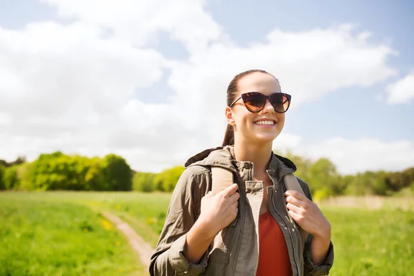 Happy young woman with backpack hiking outdoors — Stock Photo, Image