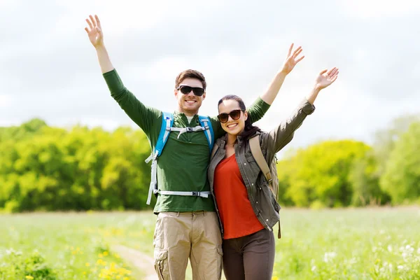 Happy couple with backpacks hiking outdoors — Stock Photo, Image