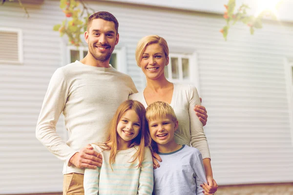 Happy family in front of house outdoors Stock Photo