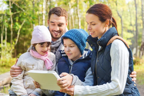 Happy family with tablet pc at camp — Stock Photo, Image