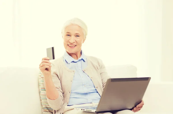 Senior woman with laptop and credit card at home — Stock Photo, Image