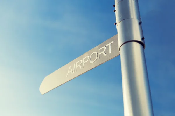Close up of airport signpost over blue sky — Stock Photo, Image