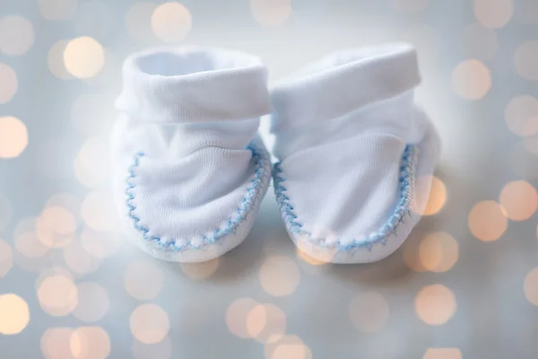 Close up of white baby boots for newborn boy — стоковое фото
