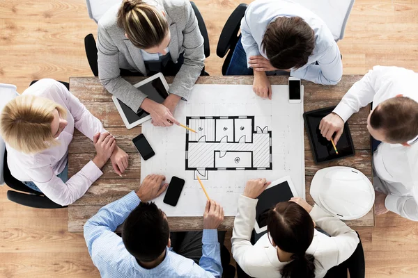 Close up of business team sitting at table — Stock Photo, Image