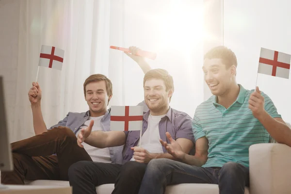 Happy male friends with flags and vuvuzela — Stock Photo, Image