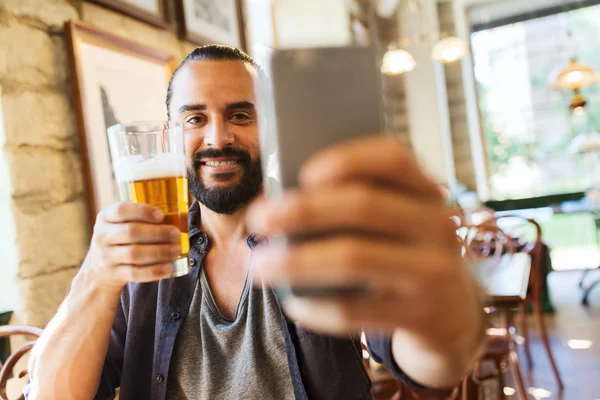 Homem com smartphone bebendo cerveja — Fotografia de Stock