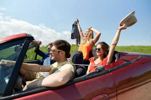 Happy friends driving in cabriolet car — Stock Photo, Image