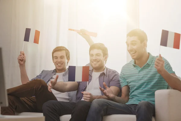 Happy male friends with flags and vuvuzela — Stock Photo, Image