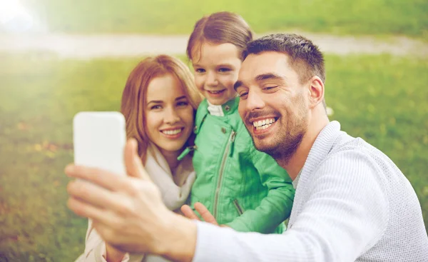 Happy family taking selfie by smartphone — Stock Photo, Image