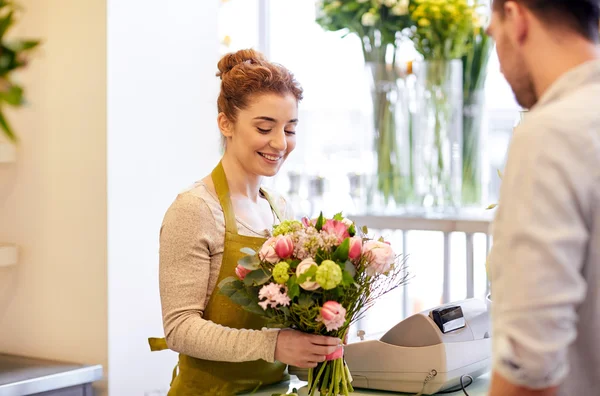 Florista mulher e homem na loja de flores — Fotografia de Stock