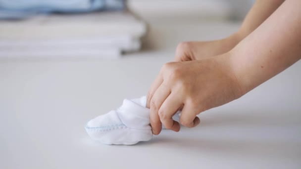 Woman hands with baby bootees — Stock Video